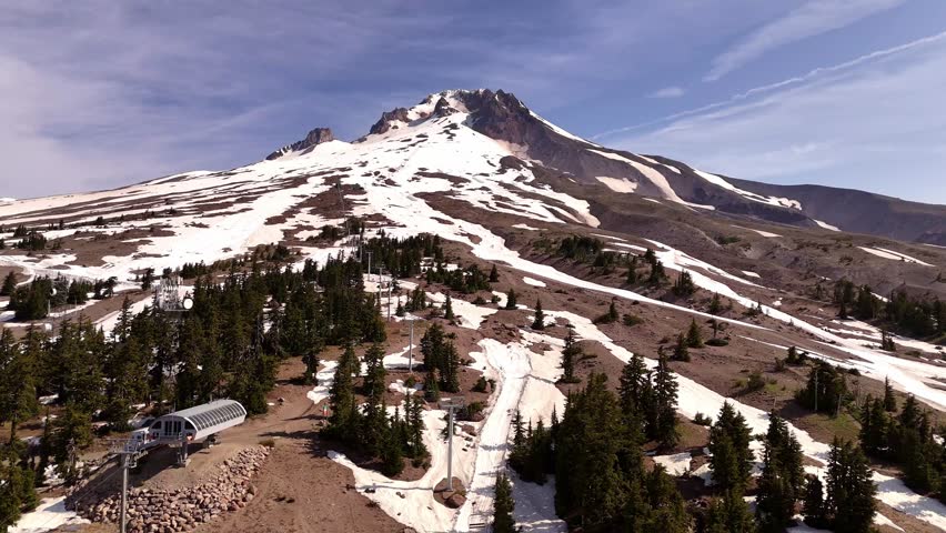 Mount Hood and summer ski slope area, with the ski lifts in the foreground. Clear sky and sunshine