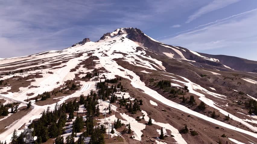 Mount Hood and summer ski slope area, with the ski lifts in the foreground. Clear sky and sunshine