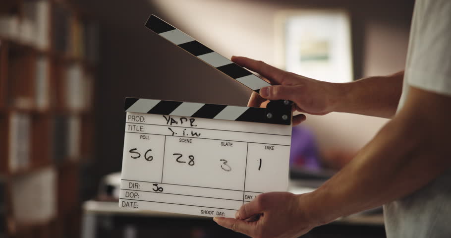 Production, scene or hands with clapboard on set for photography, video recording or filming movie. Backstage, media crew or person ready with slate for photoshoot, content or blurred model in action