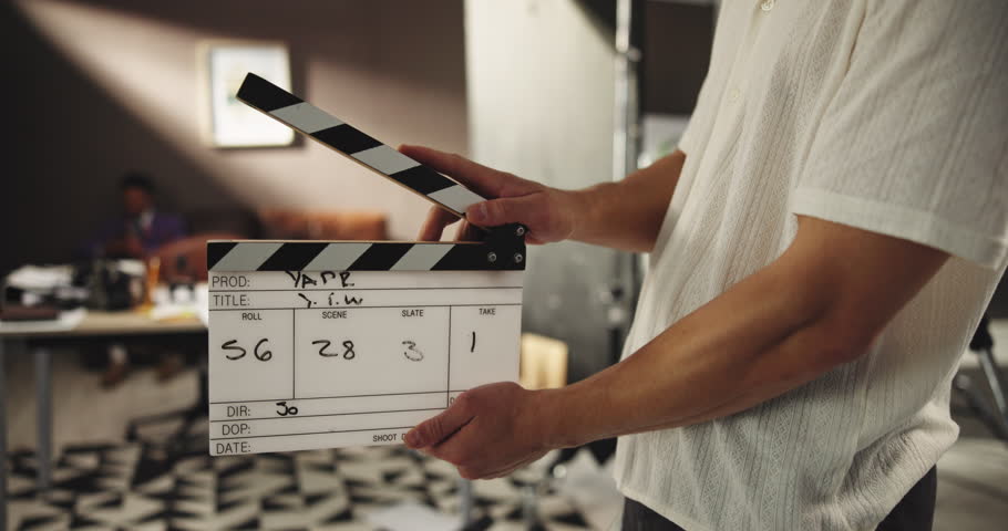 Filming, production and hands with clapboard on set for photography, video recording or movie scene. Audio sync, backstage and person with slate for photoshoot action, content and behind the scenes