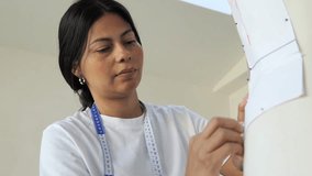 Fashion design student creates clothing patterns in studio workspace during daytime - Powered by Shutterstock - Get 15% off with code: PIKWIZARD15