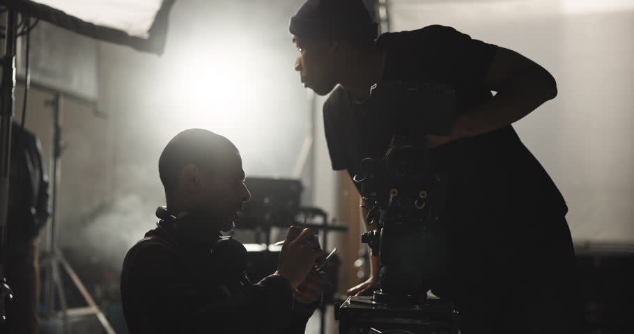 Film, maintenance and men with camera in studio for lens adjustment, process and equipment settings. Cinematography, operator and videographer with assistant for shooting, production and filmmaking
