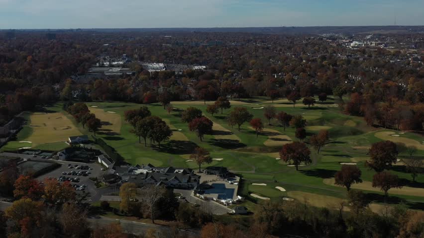 Aerial view of a vibrant golf course with lush green fairways and colorful trees, creating a beautiful contrast of colors and textures, Cincinnati, Ohio, United States.