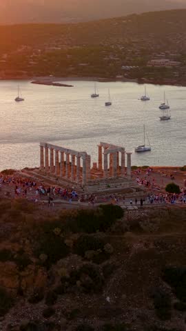 Aerial view of the ancient Temple of Poseidon at Cape Sounion, Attica, Greece, during a beautiful summer sunset