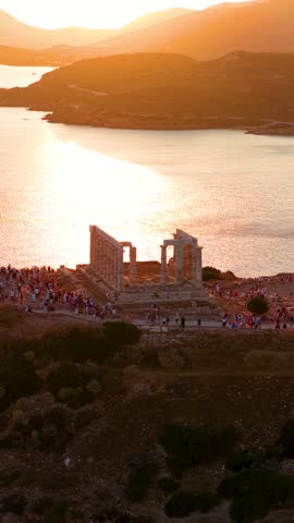 Aerial view of the ancient Temple of Poseidon at Cape Sounion, Attica, Greece, during a beautiful summer sunset