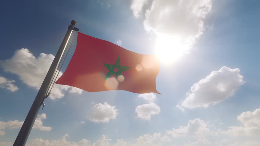 Morocco Flag on a Flagpole with a cloudy blue sky background