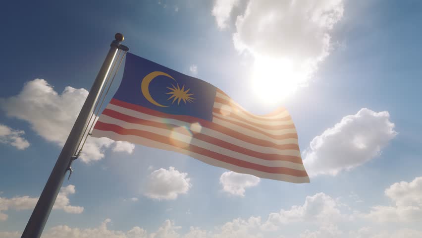 Malaysia Flag on a Flagpole with a cloudy blue sky background