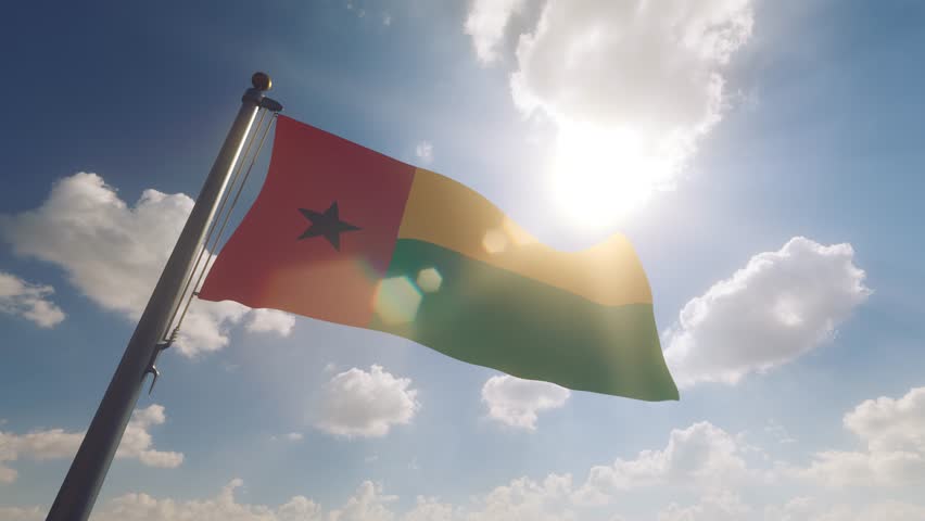 Guinea-Bissau Flag on a Flagpole with a cloudy blue sky background