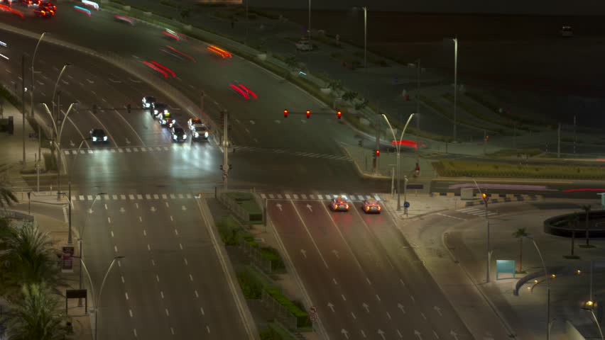Busy city vehicular traffic intersection, crossroads, or junction in Abu Dhabi, United Arab Emirates - nighttime time lapse with smooth motion blur
