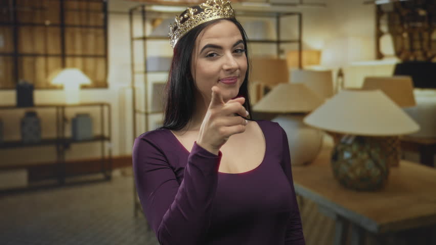 Hispanic woman with crown gesturing 