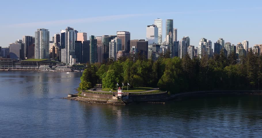 Vancouver , British Columbia , Canada - 05 06 2025: Vancouver, British Columbia: Majestic City Skyline Across Blue Water with Stanley Park Peninsula.