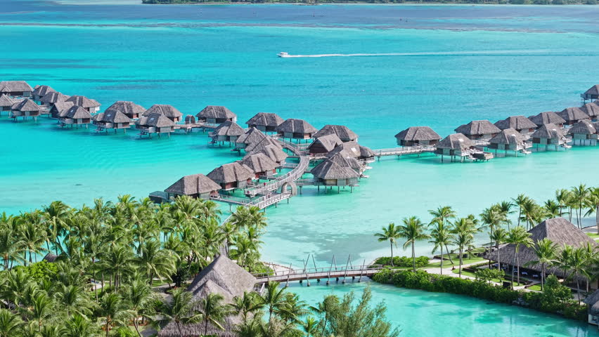 Bora Bora Island, French Polynesia. Aerial View of Overwater Bungalows of Luxury Tropical Resort and Turquoise Lagoon Water