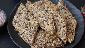 Crispbread, thin bread with seeds and grains, a baked cracker. Crispbread with pumpkin seeds and flax and sesame seeds - Powered by Shutterstock - Get 15% off with code: PIKWIZARD15