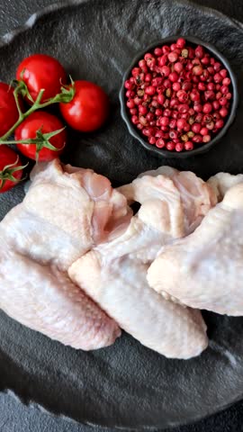 Raw chicken wings, fresh uncooked poultry meat. Chicken or turkey wings with salt and spices