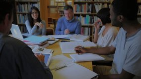 Students and professor discussing math in library, with √9=3 fading in, formulas surrounding laptop. Collaboration, learning, academia, education, intellectual, teamwork, research - Powered by Shutterstock - Get 15% off with code: PIKWIZARD15