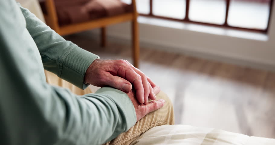 Anxiety, concern and stress with hands of old person in bedroom of retirement home for uncertainty. Afraid, thinking and worry with nervous senior in apartment for difficulty, phobia or memory loss