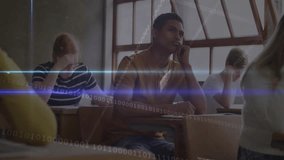 Teen boy pausing writing and gazing forward triggers tech binary streams filling classroom desks. Education, classroom, digital, technology, adolescents, study, innovation - Powered by Shutterstock - Get 15% off with code: PIKWIZARD15