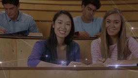 Female students picking pen and sharing notes in lecture hall with network overlay showing learning. Collaboration, education, technology, inspiration, teamwork, university, innovation - Powered by Shutterstock - Get 15% off with code: PIKWIZARD15