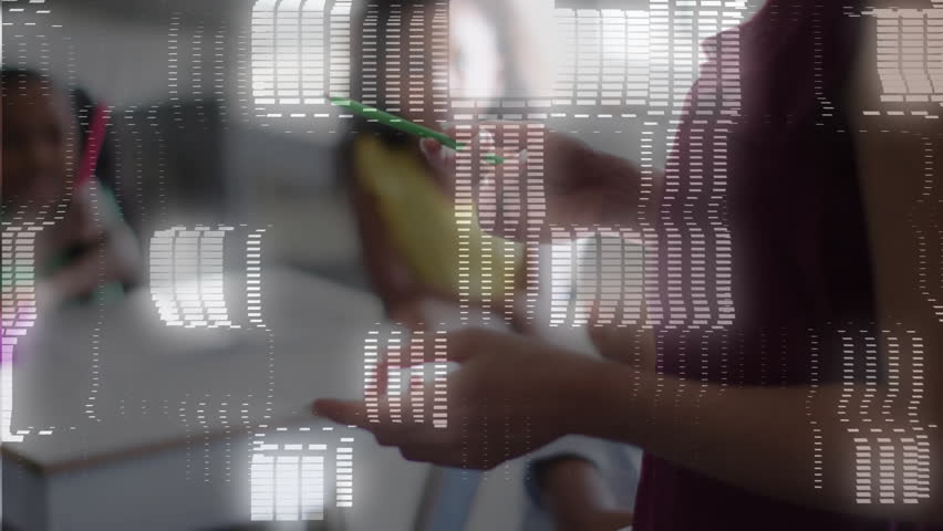 Teacher raising marker toward yellow object at desk sparking blocks shifting into binary stream. Education, mentorship, classroom, data visualization, digital transformation, learning, teaching - Powered by Shutterstock - Get 15% off with code: PIKWIZARD15