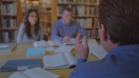 Professor gesturing while activating AR overlay in library showing nodes and 3D globe for education. Innovation, collaboration, technology, education, networking, digital, academic - Powered by Shutterstock - Get 15% off with code: PIKWIZARD15