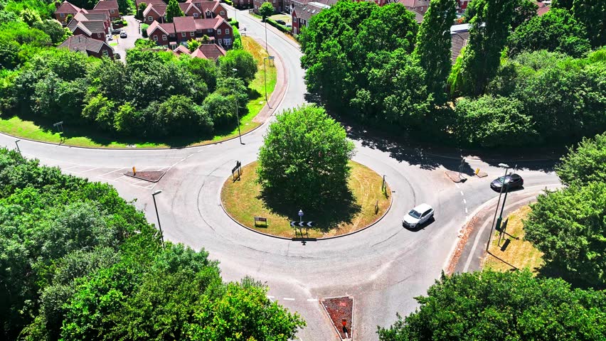 Aerial Low Angle Small Urban Roundabout Slowly Panning Up 