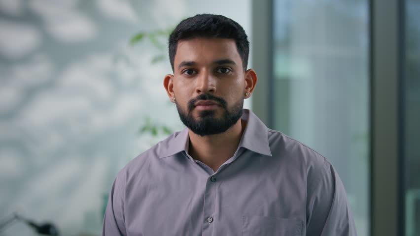 Portrait in office Arabian ethnic Muslim business man posing in workplace serious calm businessman looking at camera male professional guy worker corporate CEO manager employer entrepreneur agent