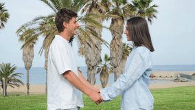 Delighted couple holding hands, enjoying each other company with bright smiles and laughter outdoors, creating a joyful and affectionate moment filled with love and happiness. - Powered by Shutterstock - Get 15% off with code: PIKWIZARD15