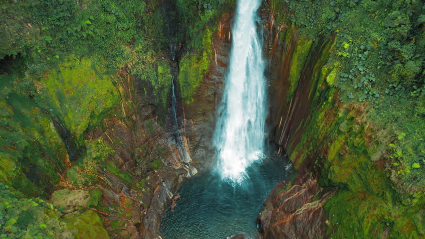 Blue Falls waterfall Catarata del Toro thundering into round pool in Costa Rica