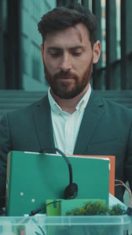 A businessman in an urban office reflects on his career ambitions and corporate life