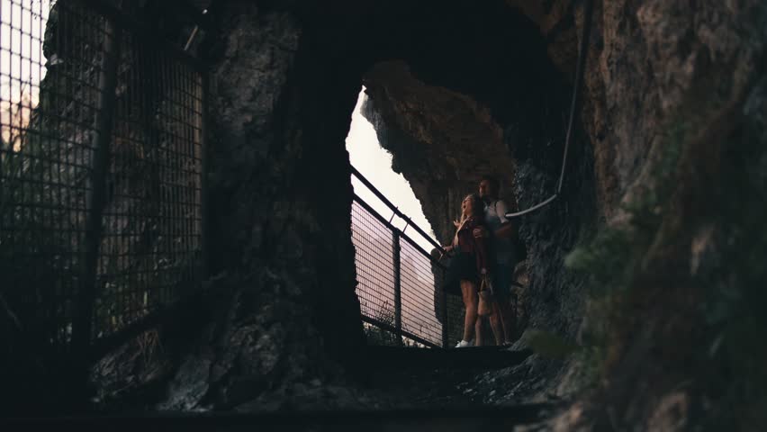 Couple in love standing hugging an observation deck. Tourist viewing platform. village Lauterbrunnen waterfall Staubbach travel. water falling over stones. landscapes of Switzerland mountain nature