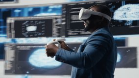 African american software developer uses virtual reality headset for coding, high tech interface workspace. Surrounded by terminal windows, representing digital programming culture. Camera B. - Powered by Shutterstock - Get 15% off with code: PIKWIZARD15