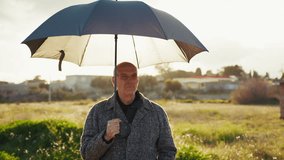Strong Winter Sun Over a Man with an Open Umbrella in Nature  - Powered by Shutterstock - Get 15% off with code: PIKWIZARD15