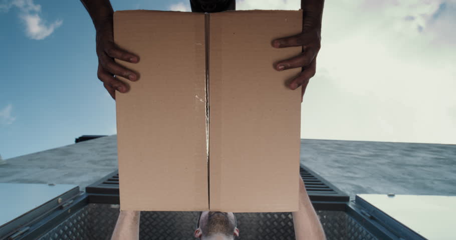 Outside of Logistics Retail Warehouse: Low Angle Shot of Multiethnic Employees Unloading Cardboard Boxes with Online Orders, Purchases and E-Commerce Goods. Working in Express Delivery Service.
