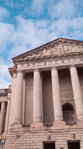 Vertical time-lapse of clouds passing over the south pediment of the William Jefferson Clinton Federal Building, headquarters of the US Environmental Protection Agency. The camera pans left to right.