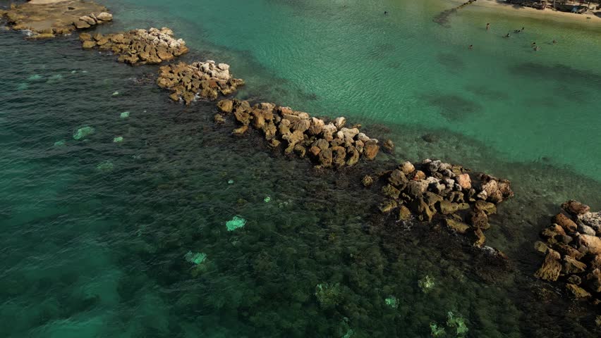 Surfers near the reef wall at Mambo Beach, Curaçao in bright daytime light.
Use: Surf promos, action reels.