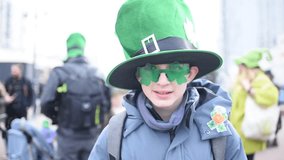 Portrait of a 12 year old boy wearing a green hat and shamrock glasses on St. Patrick's Day. - Powered by Shutterstock - Get 15% off with code: PIKWIZARD15