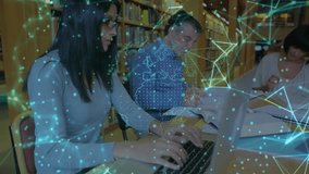 Study group typing marking pages for study with laptop, overlay appearing glowing network drifting. Collaboration, education, connection, library, technology, learning, network - Powered by Shutterstock - Get 15% off with code: PIKWIZARD15