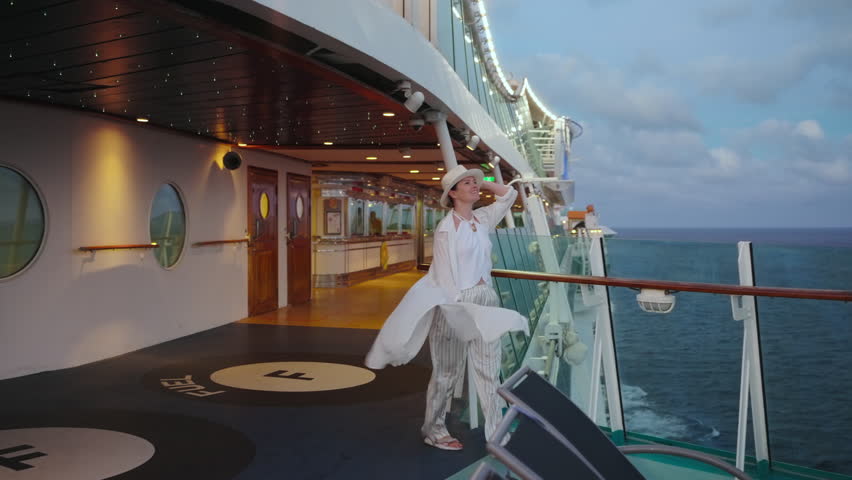 A serene scene on a cruise ship deck, showcasing a person enjoying the ocean view and sunset, surrounded by modern amenities