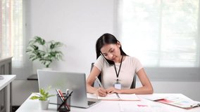 Professional businesswoman efficiently multitasking, writing notes while talking on phone, demonstrating workplace productivity and organizational skills at modern office desk - Powered by Shutterstock - Get 15% off with code: PIKWIZARD15