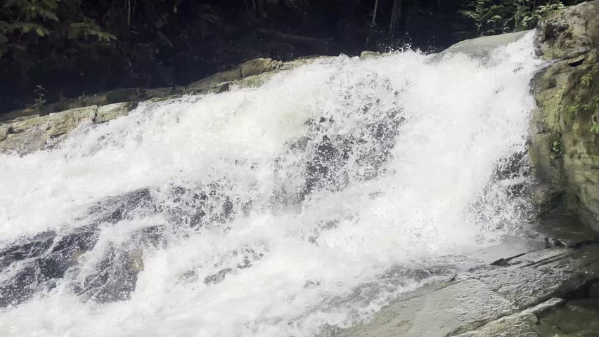 Dirung Linkin Waterfall in the tropical rainforest of Kalimantan, Indonesia. Natural environment captured in daylight. Clip #8.
