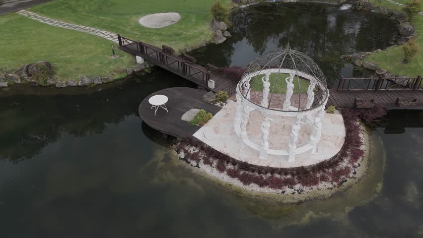 elegant island gazebo framed by water and lush garden bridges