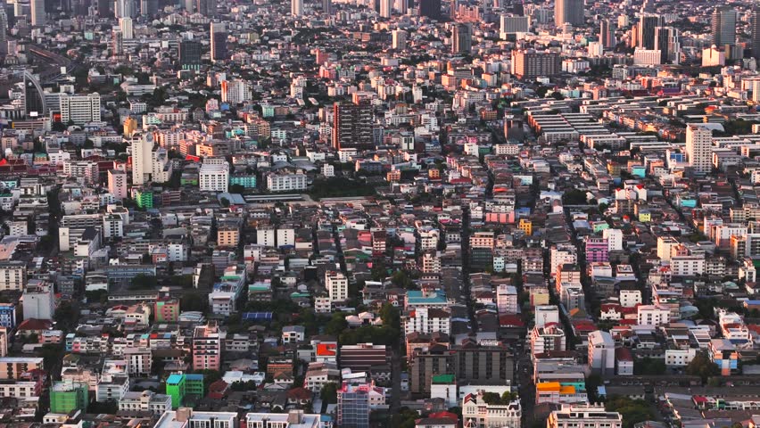 Dense aerial view of urban residential buildings and commercial blocks at golden hour