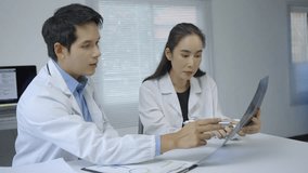 Medical professionals reviewing radiography results, collaborating on patient diagnosis in modern clinical setting with shared expertise - Powered by Shutterstock - Get 15% off with code: PIKWIZARD15