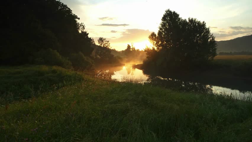 AERIAL Misty river shining in the rising sun