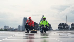 Engineer and electrician work on industrial rooftop installing solar panels and inspecting electric systems for clean renewable energy. - Powered by Shutterstock - Get 15% off with code: PIKWIZARD15