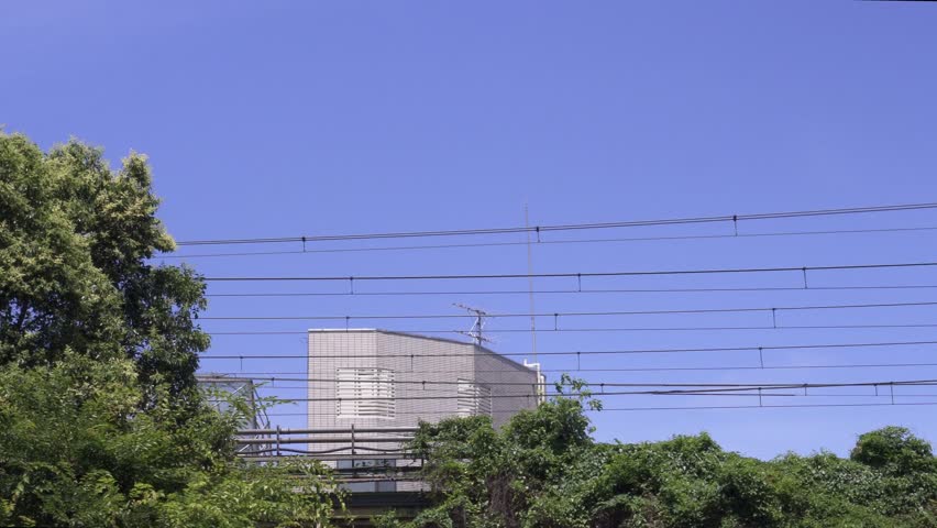Shonan-Shinjuku Line Train Passing Under Clear Blue Sky
