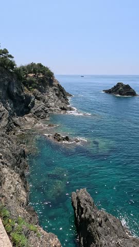 Azure sea and rock, mountains, Italy. Nature of Ligurian coast and silence, holidays in Cinque Terre. Transparent water and ecology.