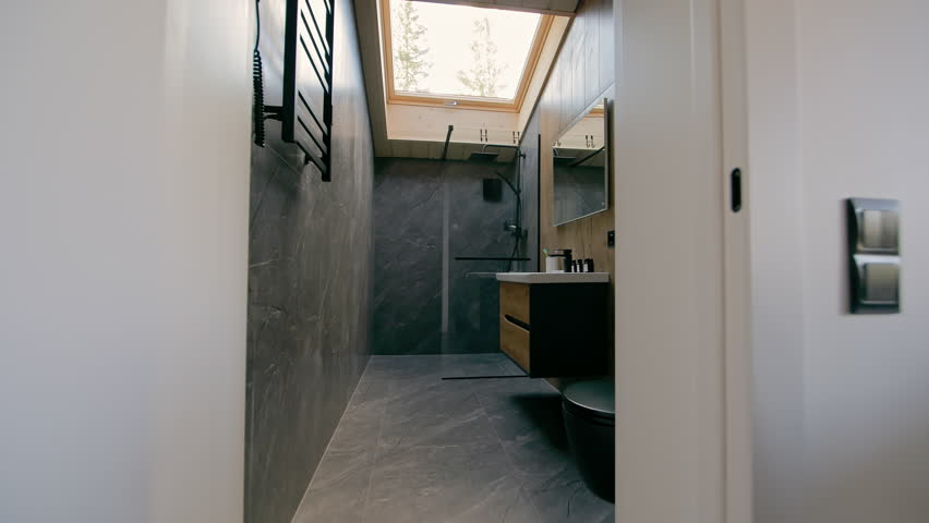Modern Bathroom Interior With Skylight and Minimalist Design, Grey Stone Walls, Shower Cabin, Floating Vanity and Natural Daylight in Contemporary Small Space Architecture