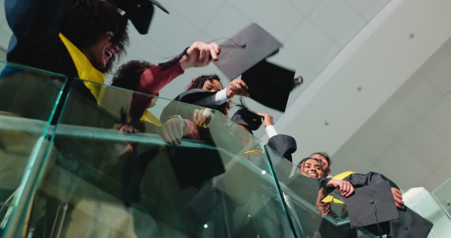 Students, hands and throw with graduation cap, celebration and success with education on stairs. People, group and goals with hat, scholarship and achievement at university campus from low angle