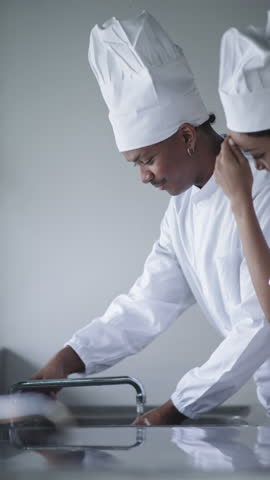 Chefs African Male and Black Female Chefs washing their hands at kitchen sink, hygiene and safe food preparation. hands in kitchen sink for hygiene and clean cooking